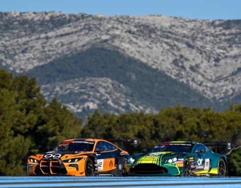 Two GT racing cars contesting a corner