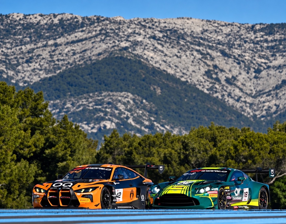 Two GT cars racing side by side into a braking zone with mountains behind